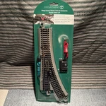 Nib Department 56- Village Animation Remote Switch Left Train Track #52807. Fixed Price $25.00.