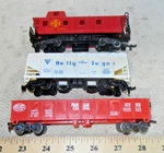 3 Freight Cars: Lionel Gondola, Bachmann Caboose, Tyco Operating Hopper (c). Fixed Price $15.00.